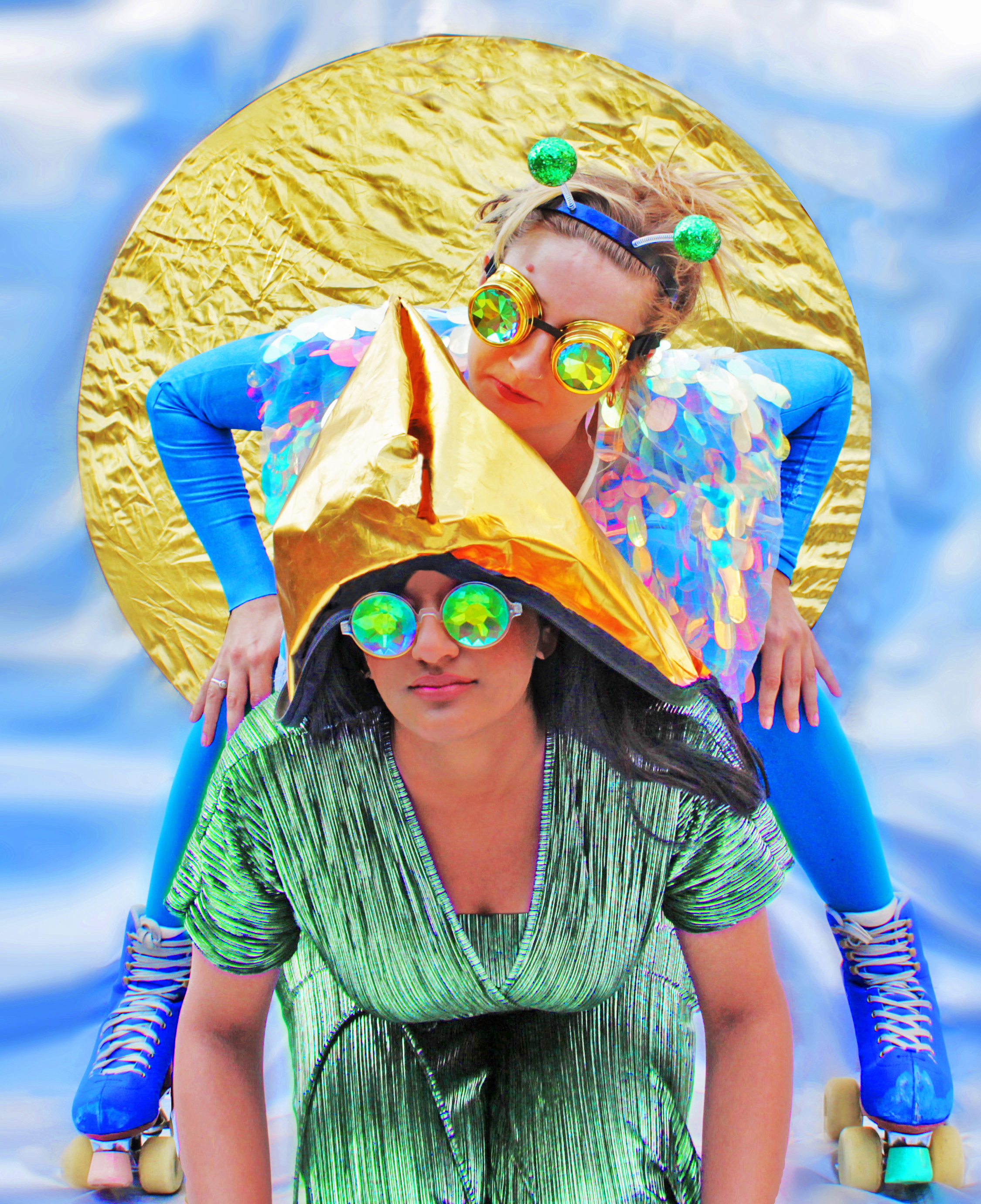 Two young women dressed in iridescent insect outfits